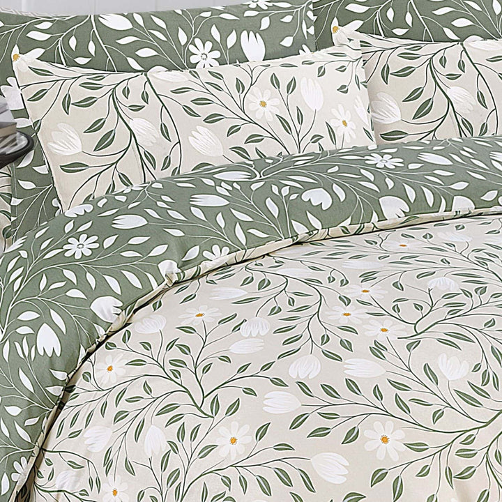 Floral and leaf patterned bedding set with pillows.